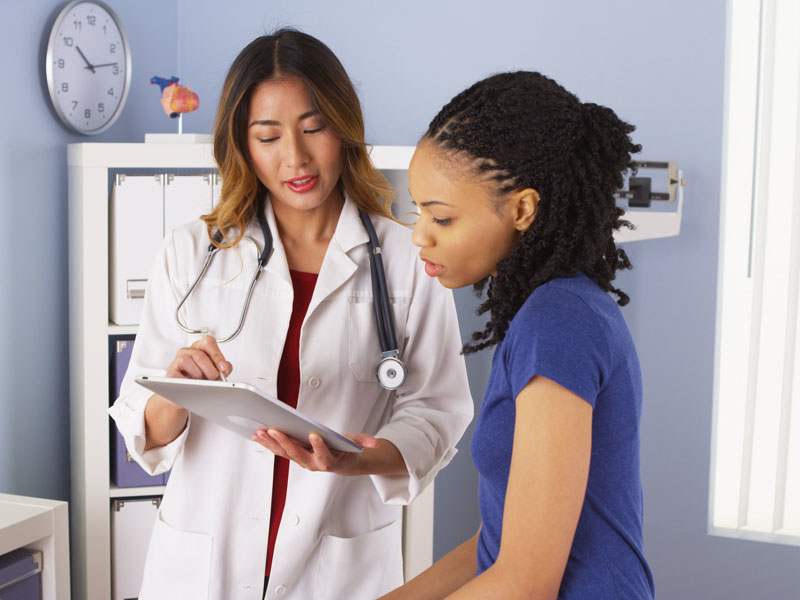 female physician talking with female patient