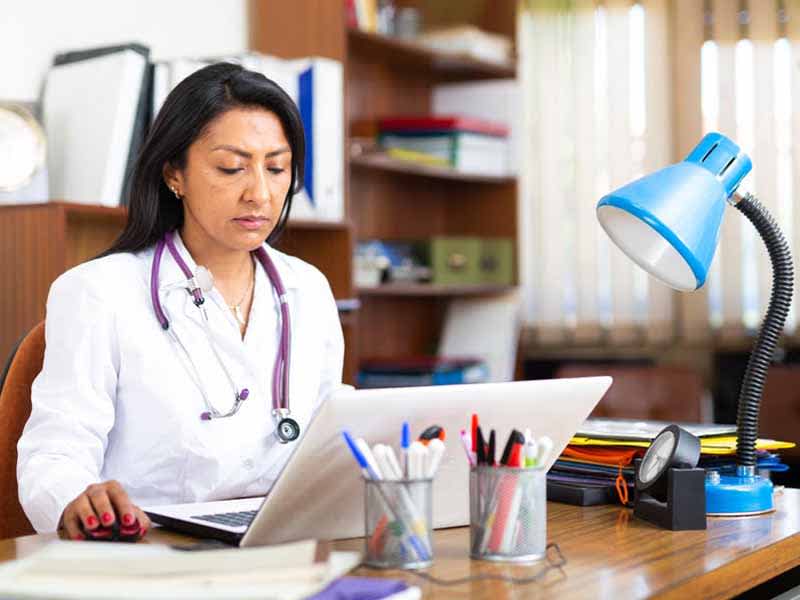 Physician looking at computer screen