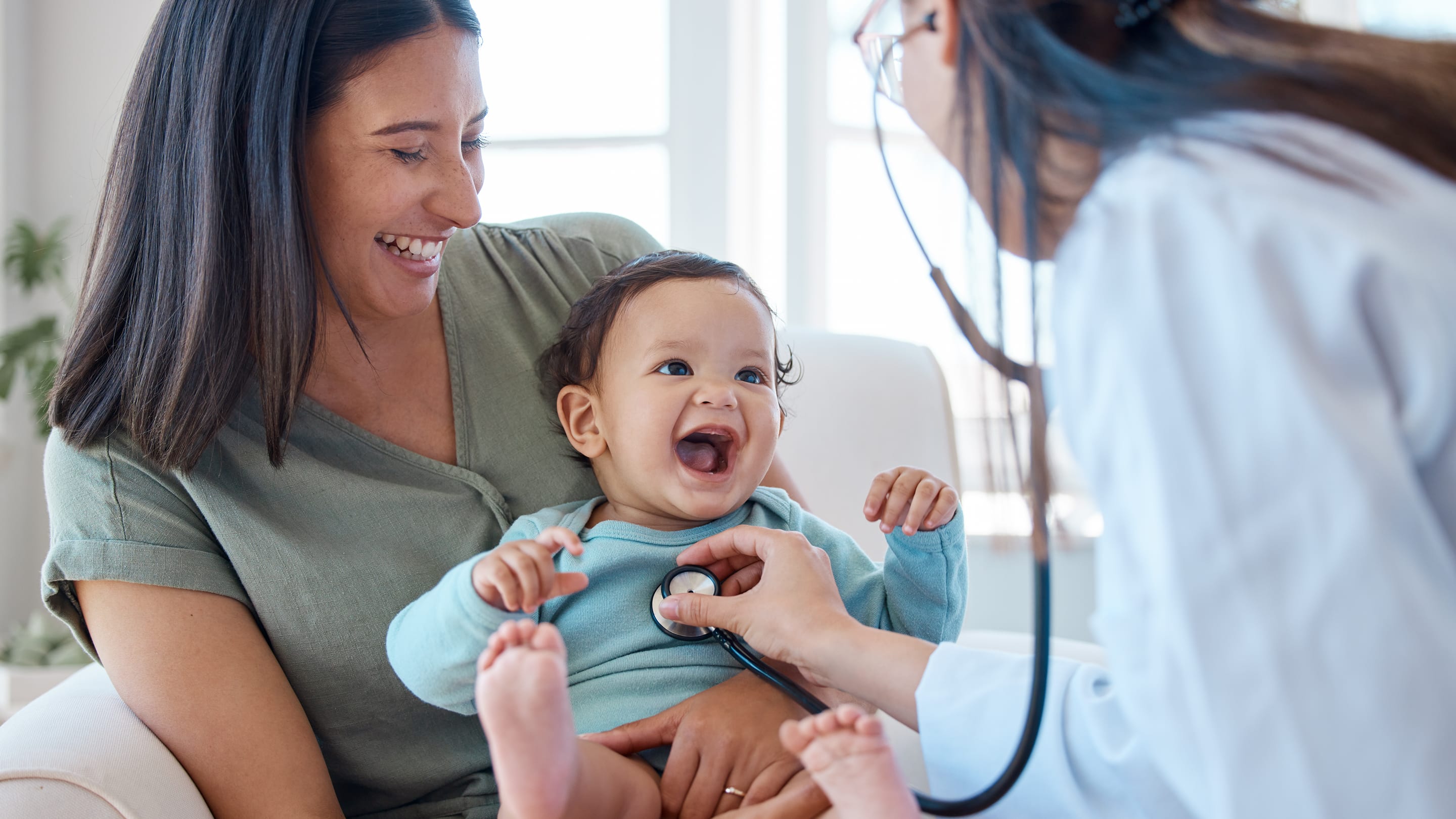 Physician listening to a young patient’s heart.