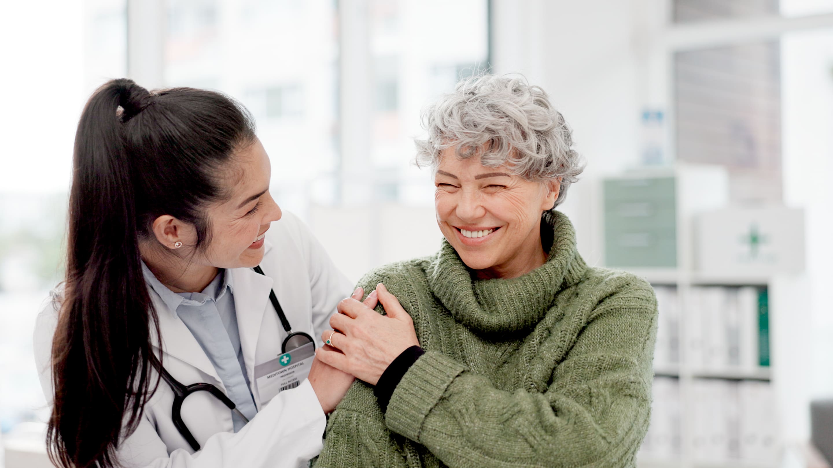 Physician and patient share a moment during a visit.