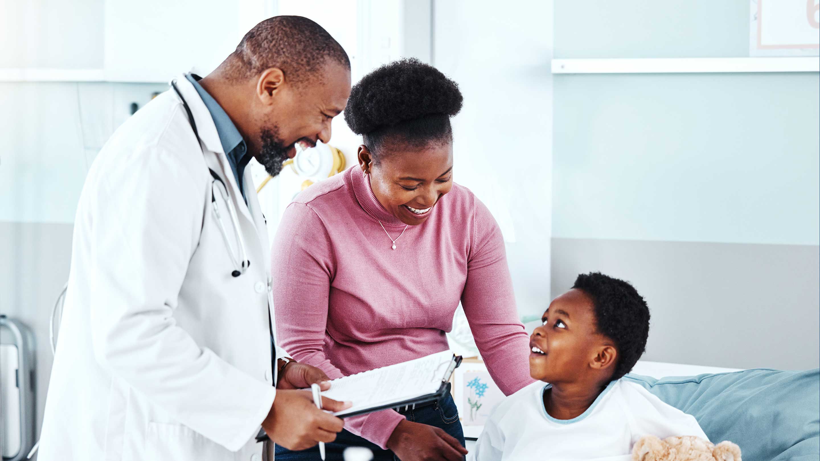 doctor with family, checkup and consultation for health and wellness. Doctor, kid and clinic bed with plush bear