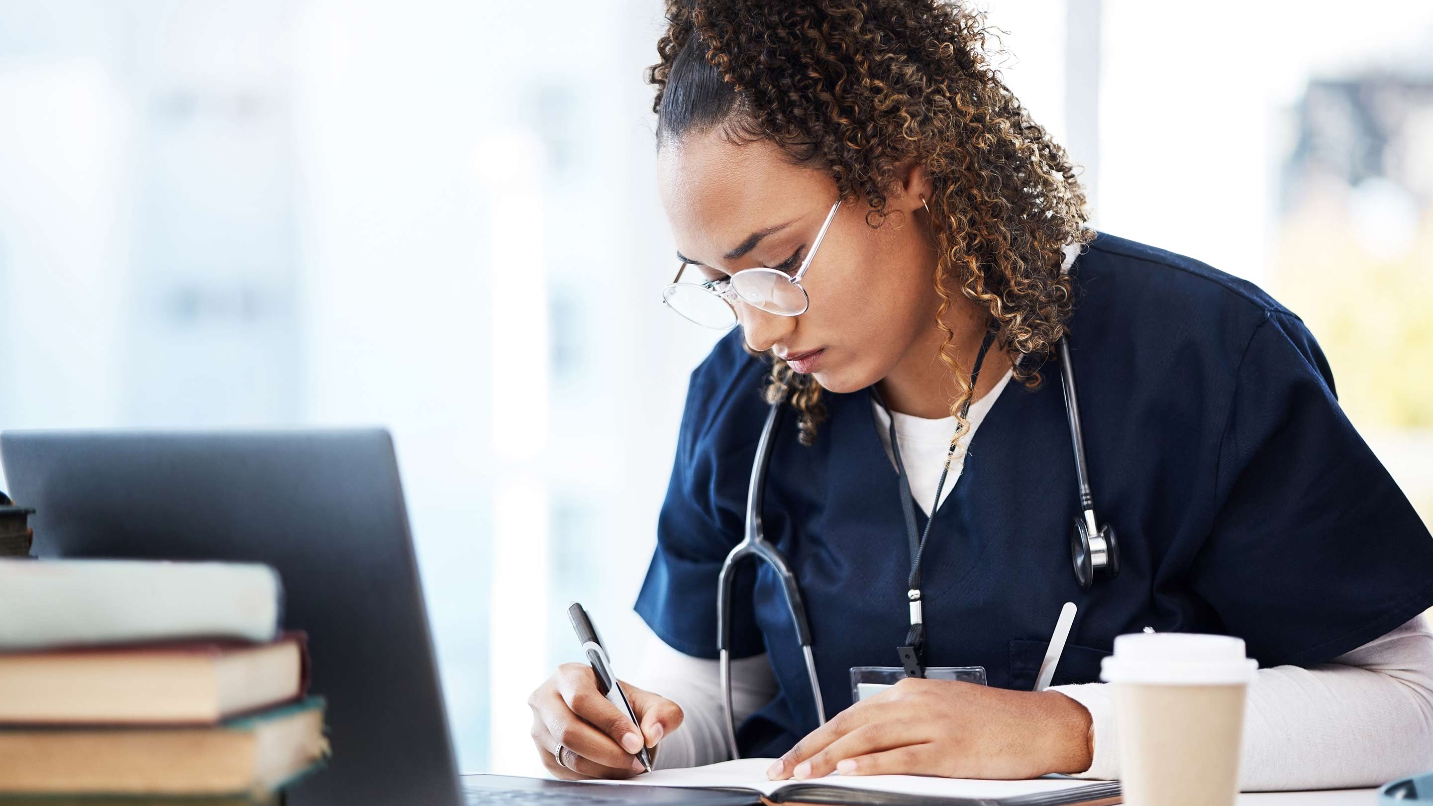Medical student doing research and taking notes.