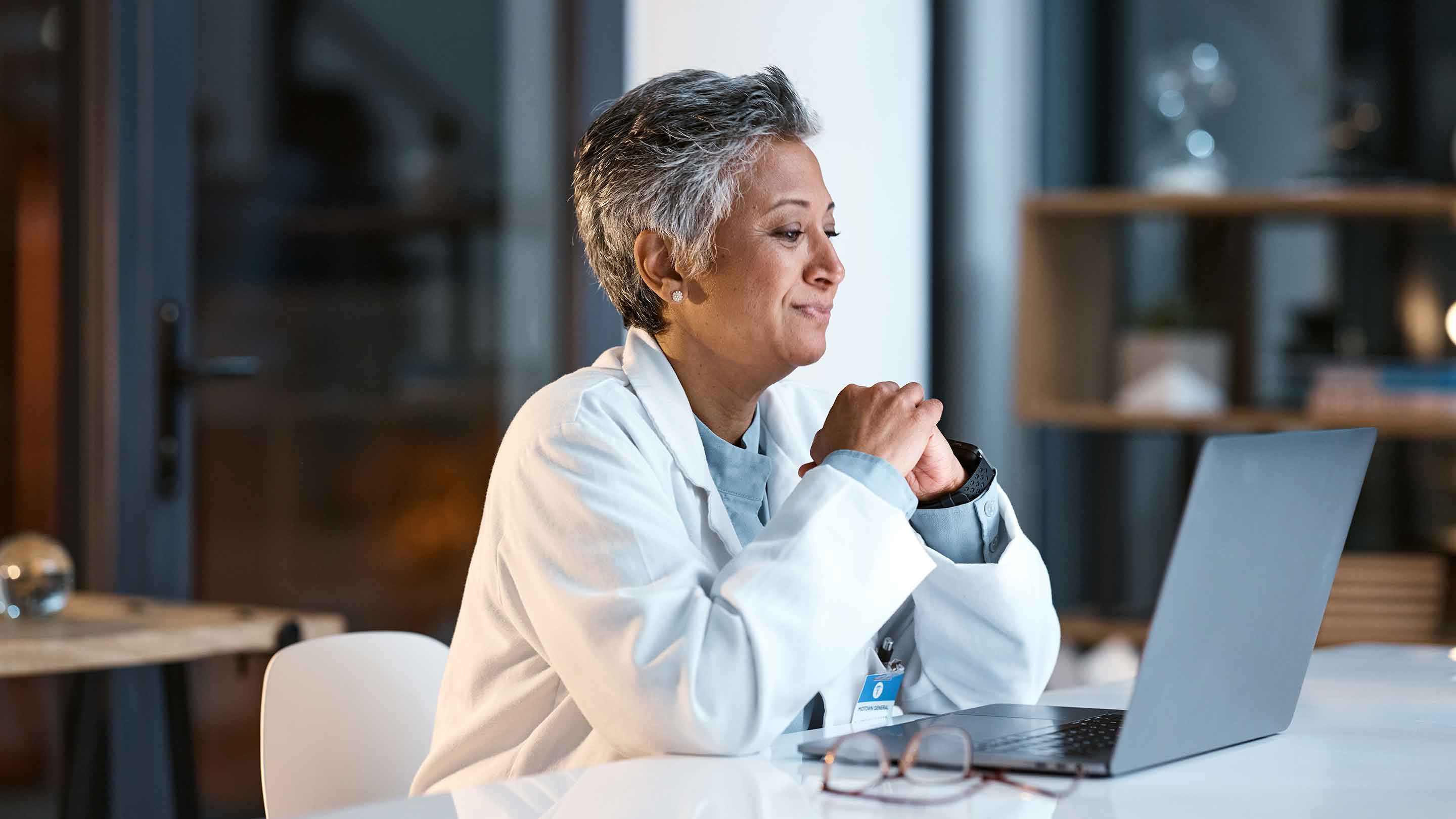 Doctor on computer doing telehealth.