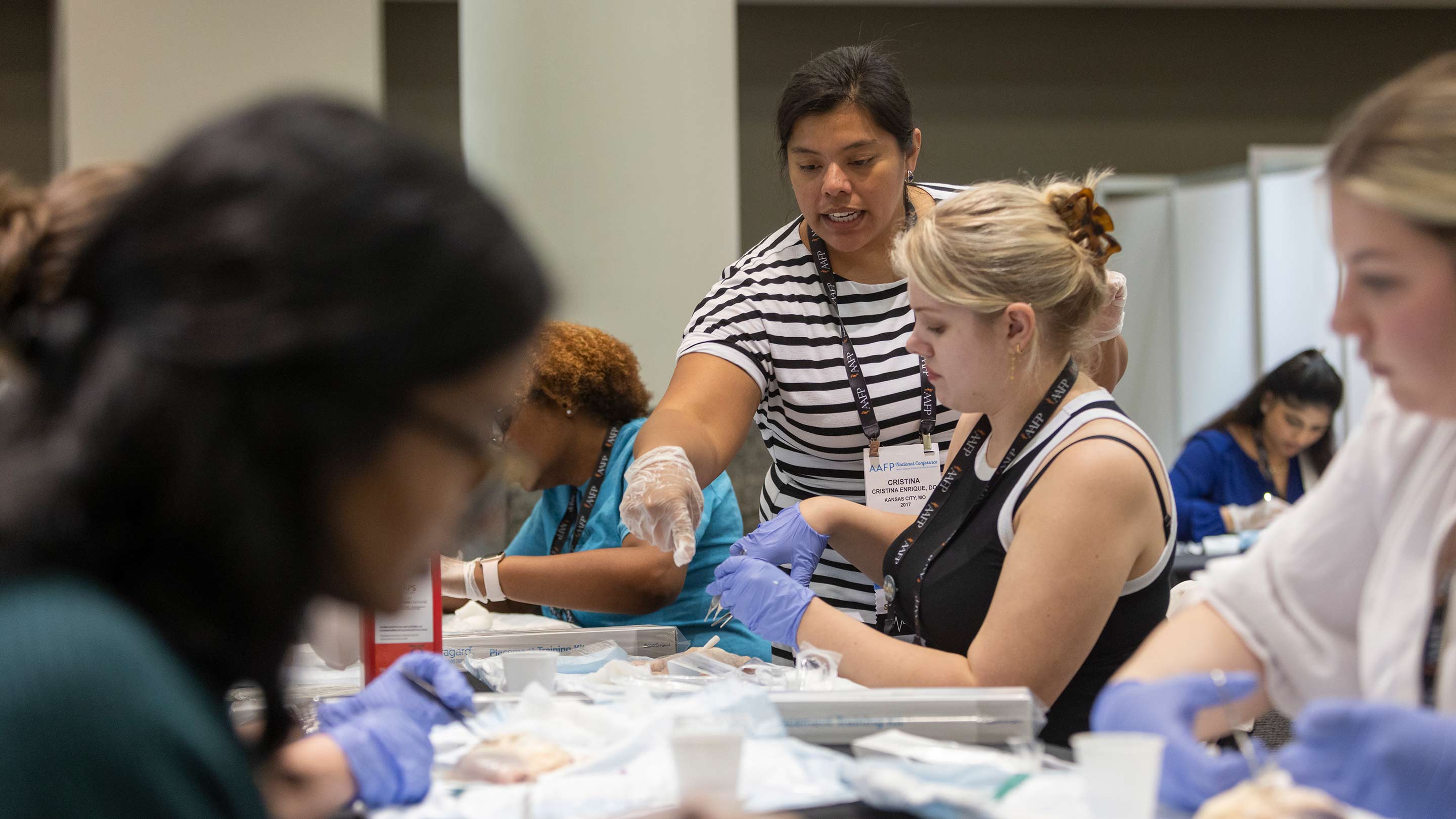 Instructor showing a student how to do clinical procedure.