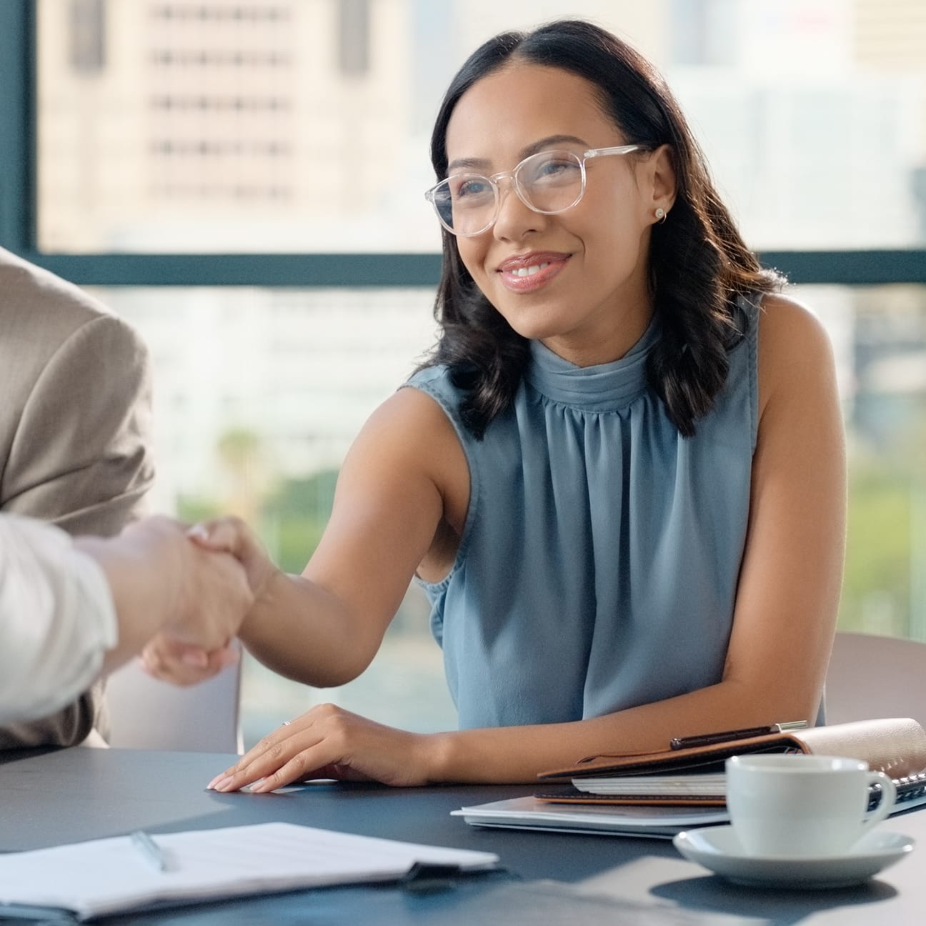 Image of two people shaking hands.