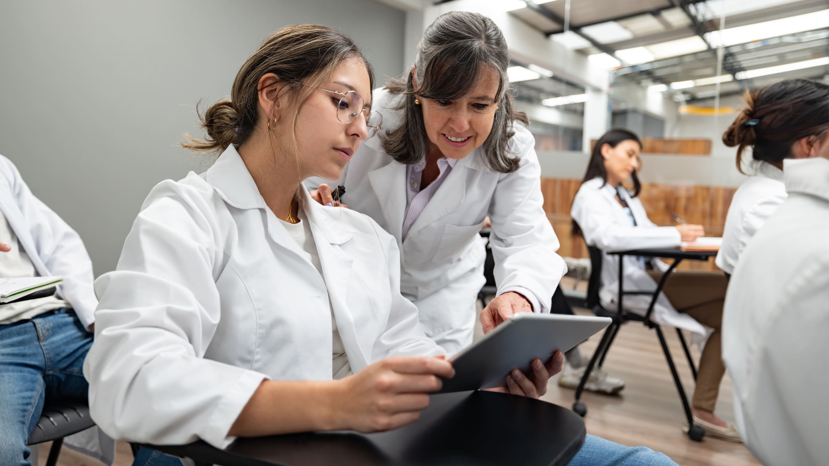 Image of med school faculty looking at tablet.