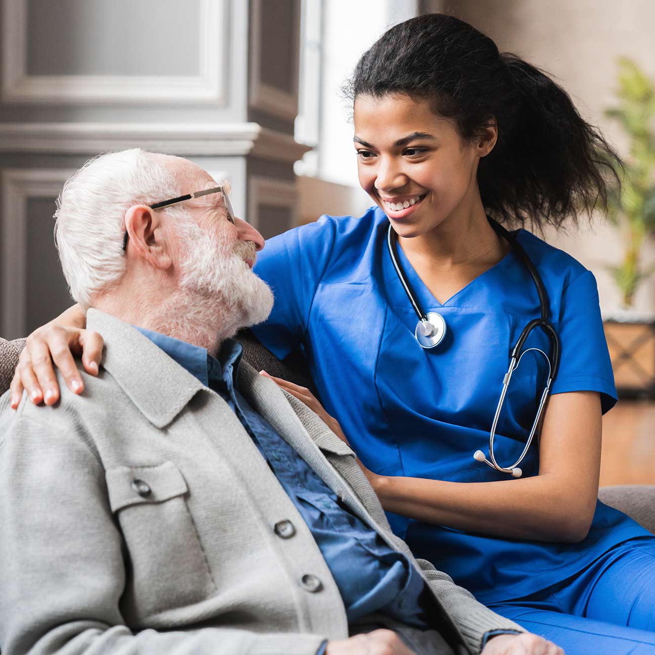young female doctor with older male patient