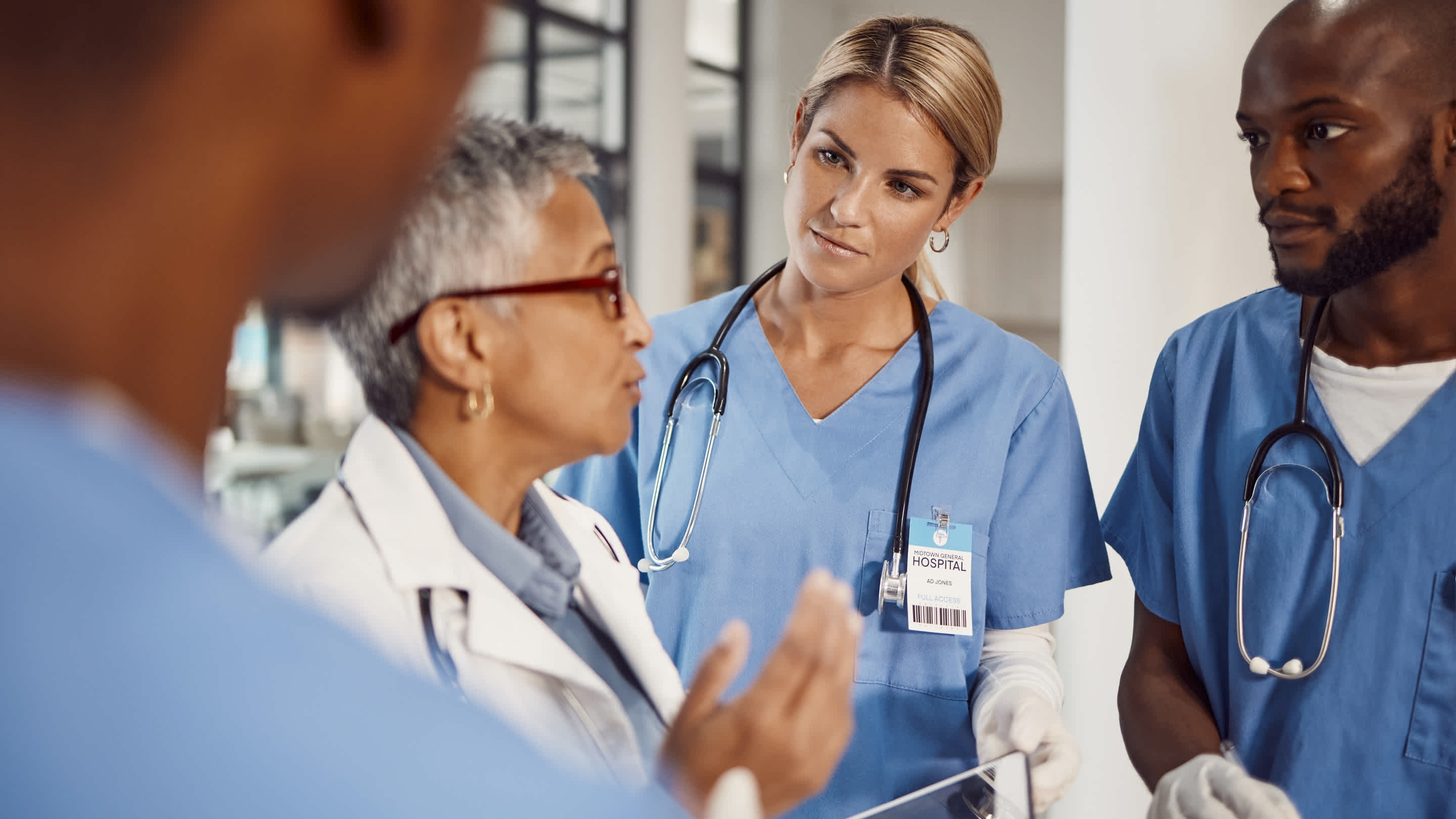 Group of doctors, planning management in hospital and workflow of medical student with training manager on tablet. Nurses, professional healthcare