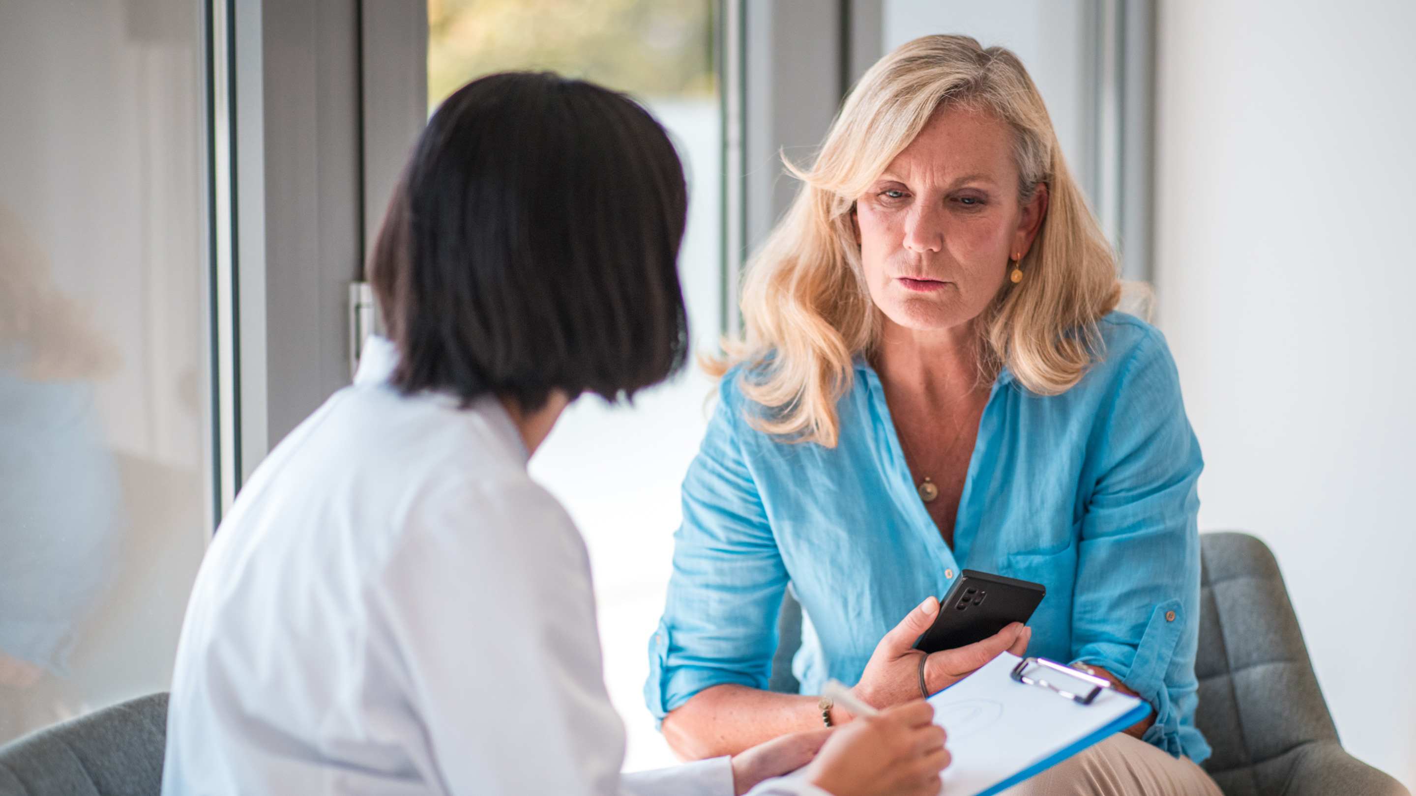 Physician and patient in conversation about mental health issues.