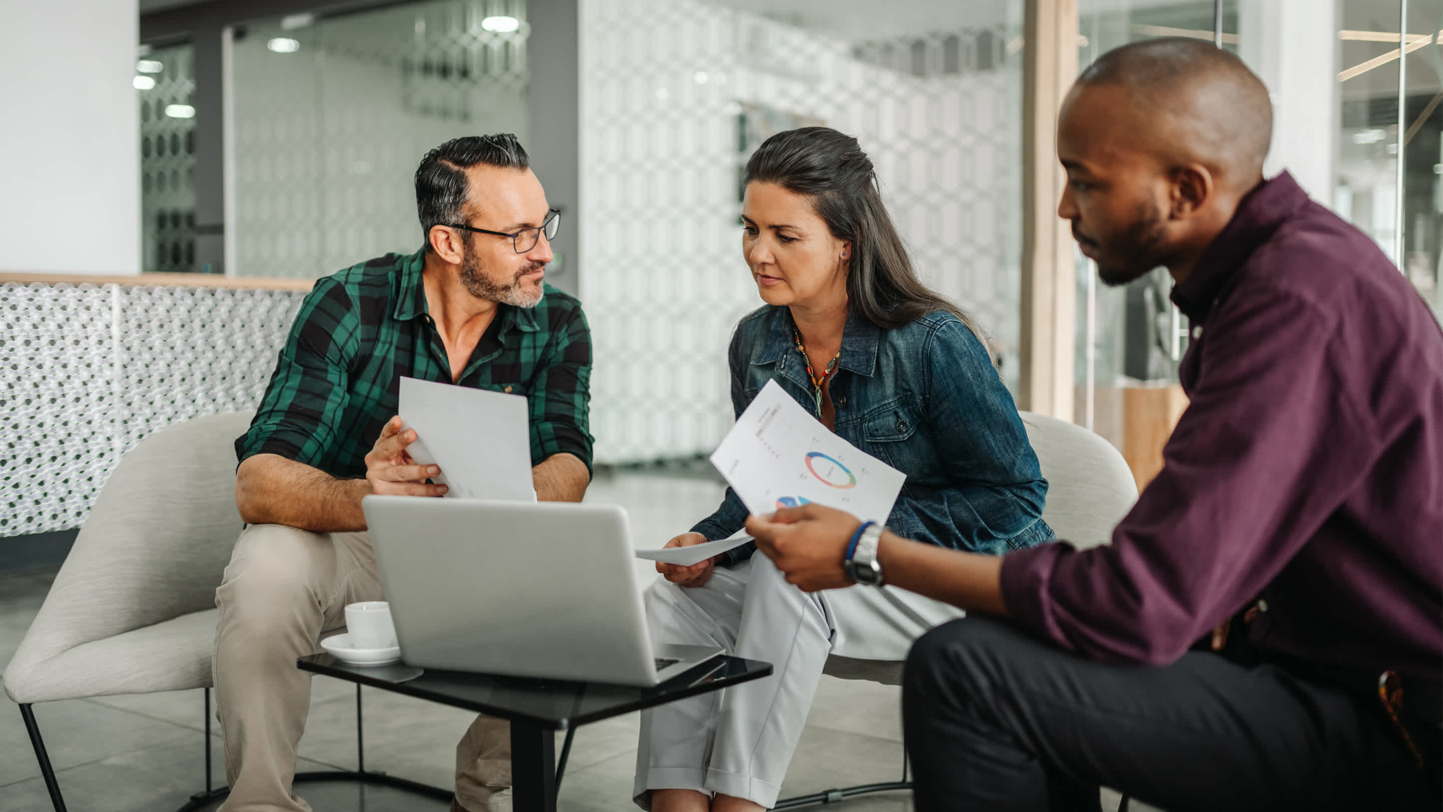 People meeting to discuss insurance at a table.