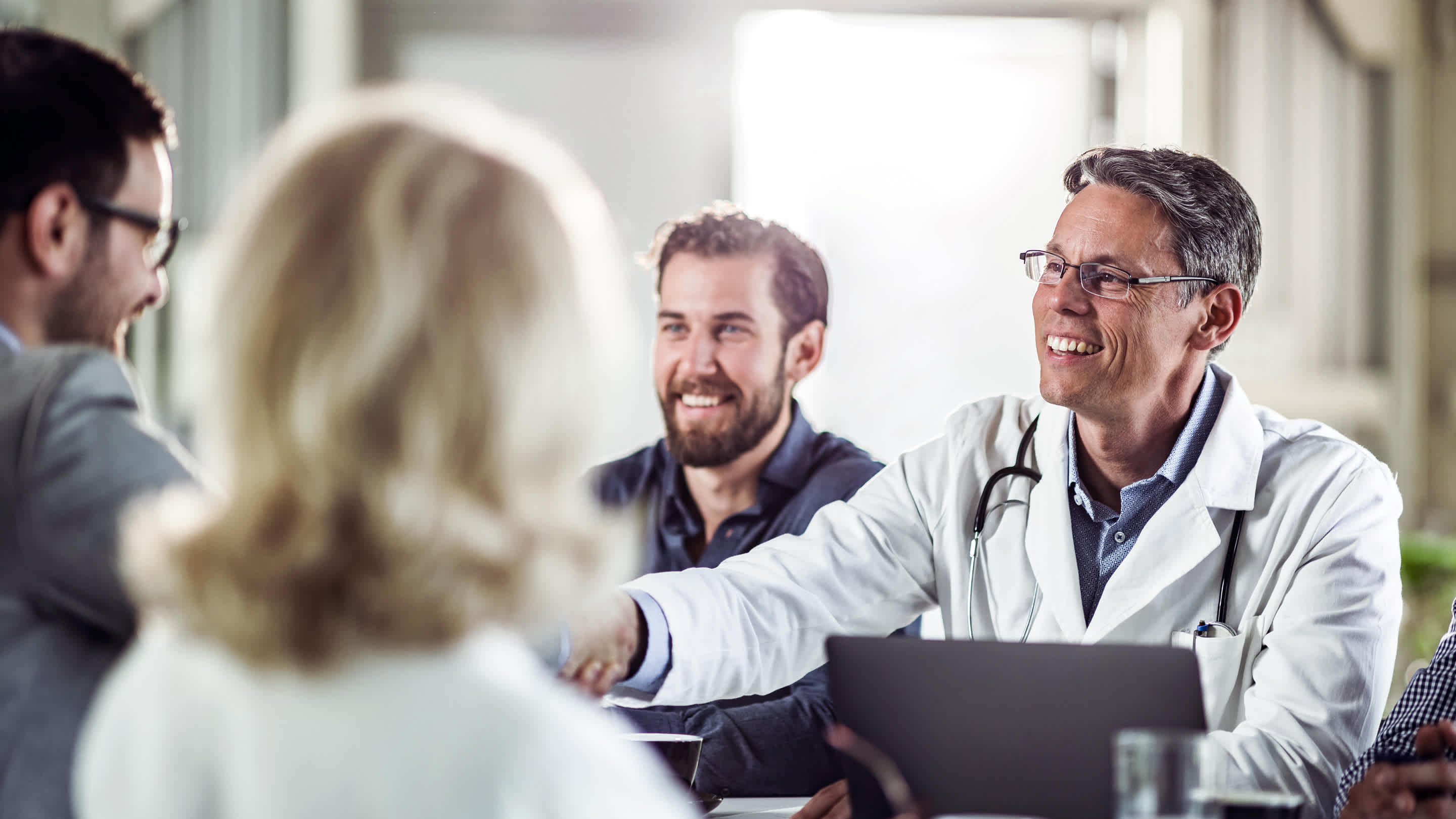 Physicians shaking hands after an interview