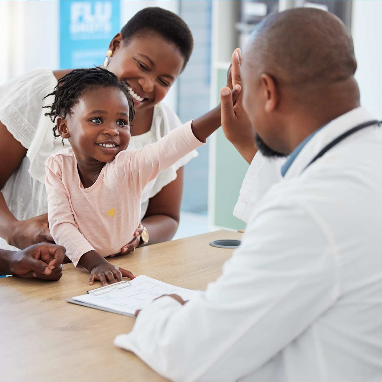 High five, physician and family during a routine appointment