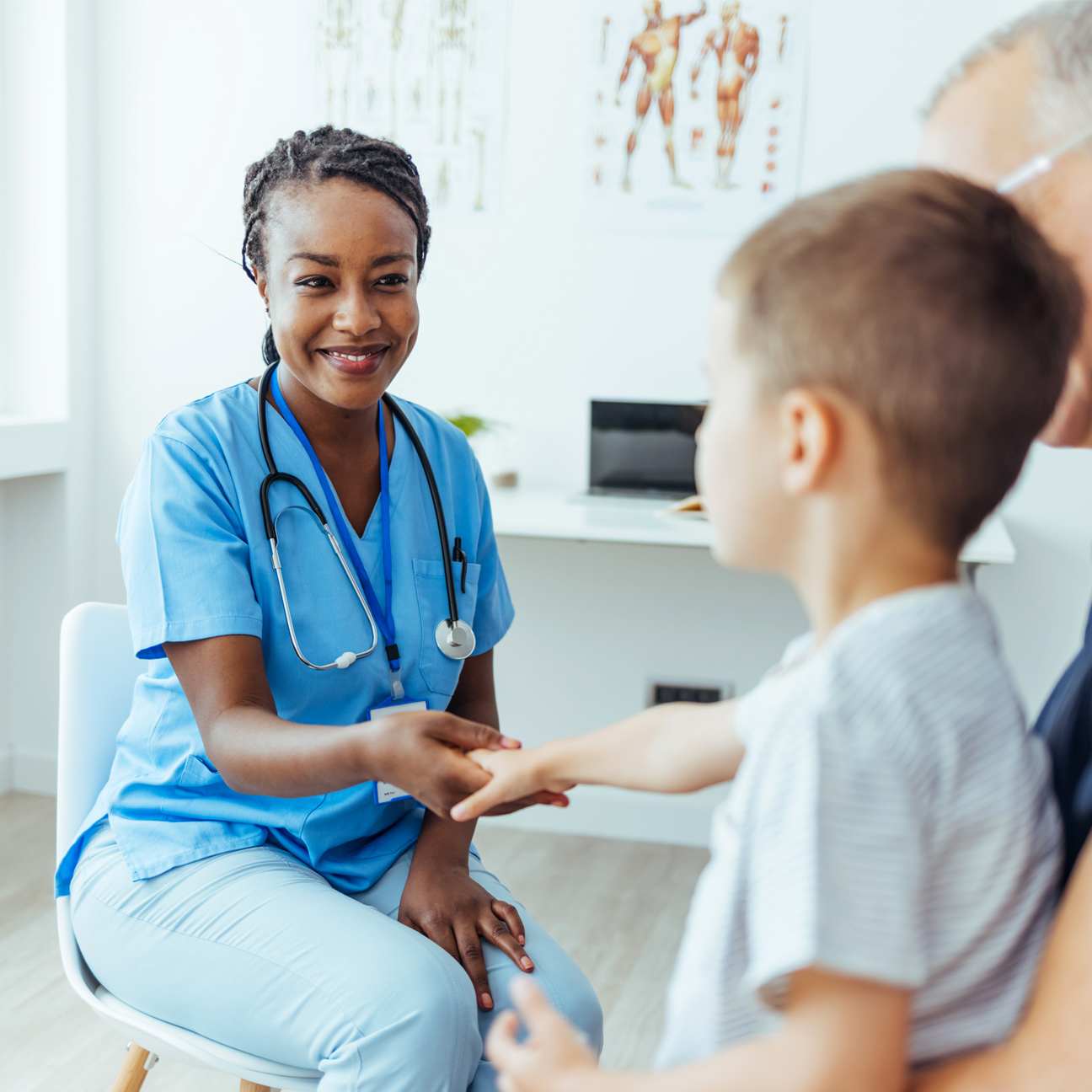 Child in a hospital with African-American woman physician.