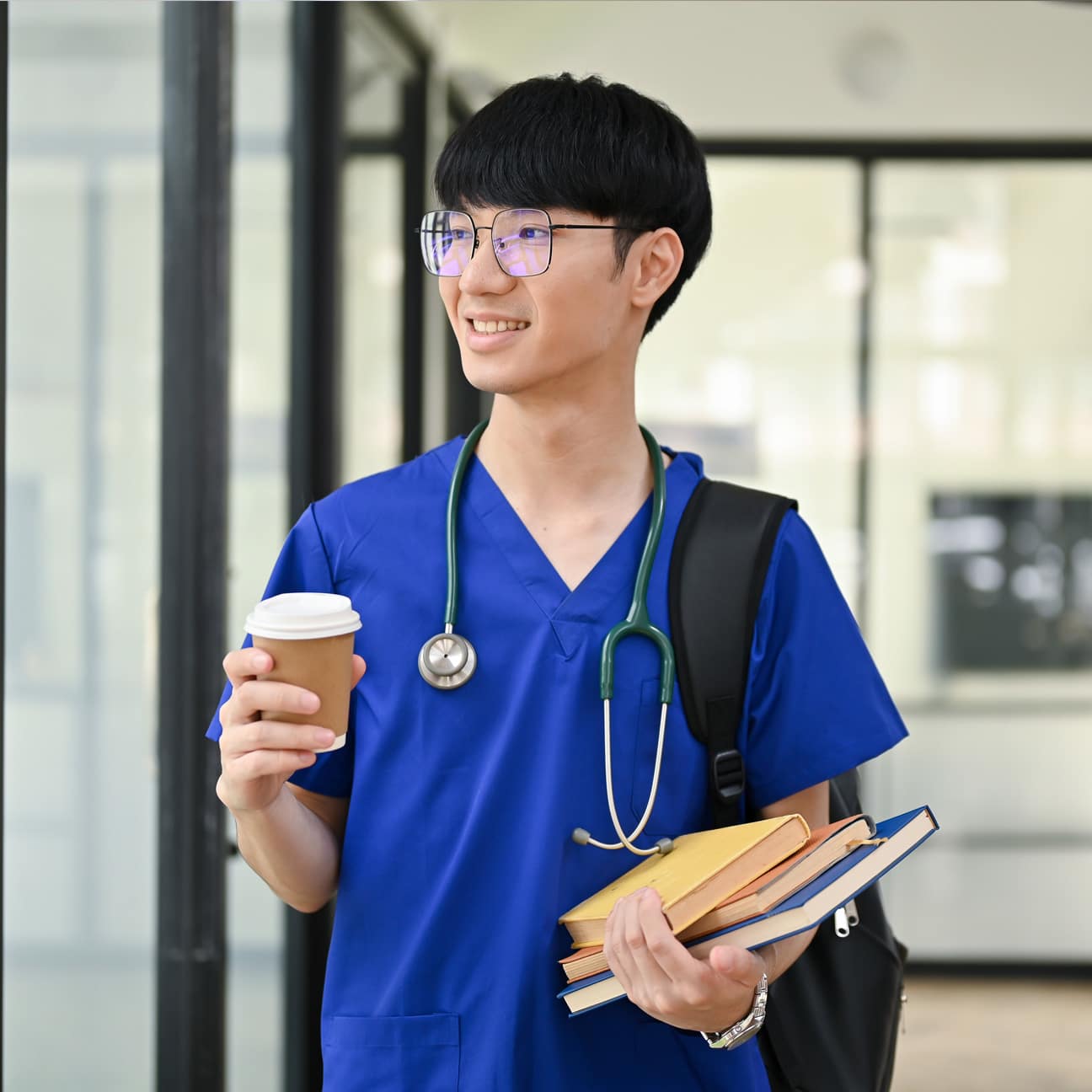 Smiling student doctor in a clinic hallway