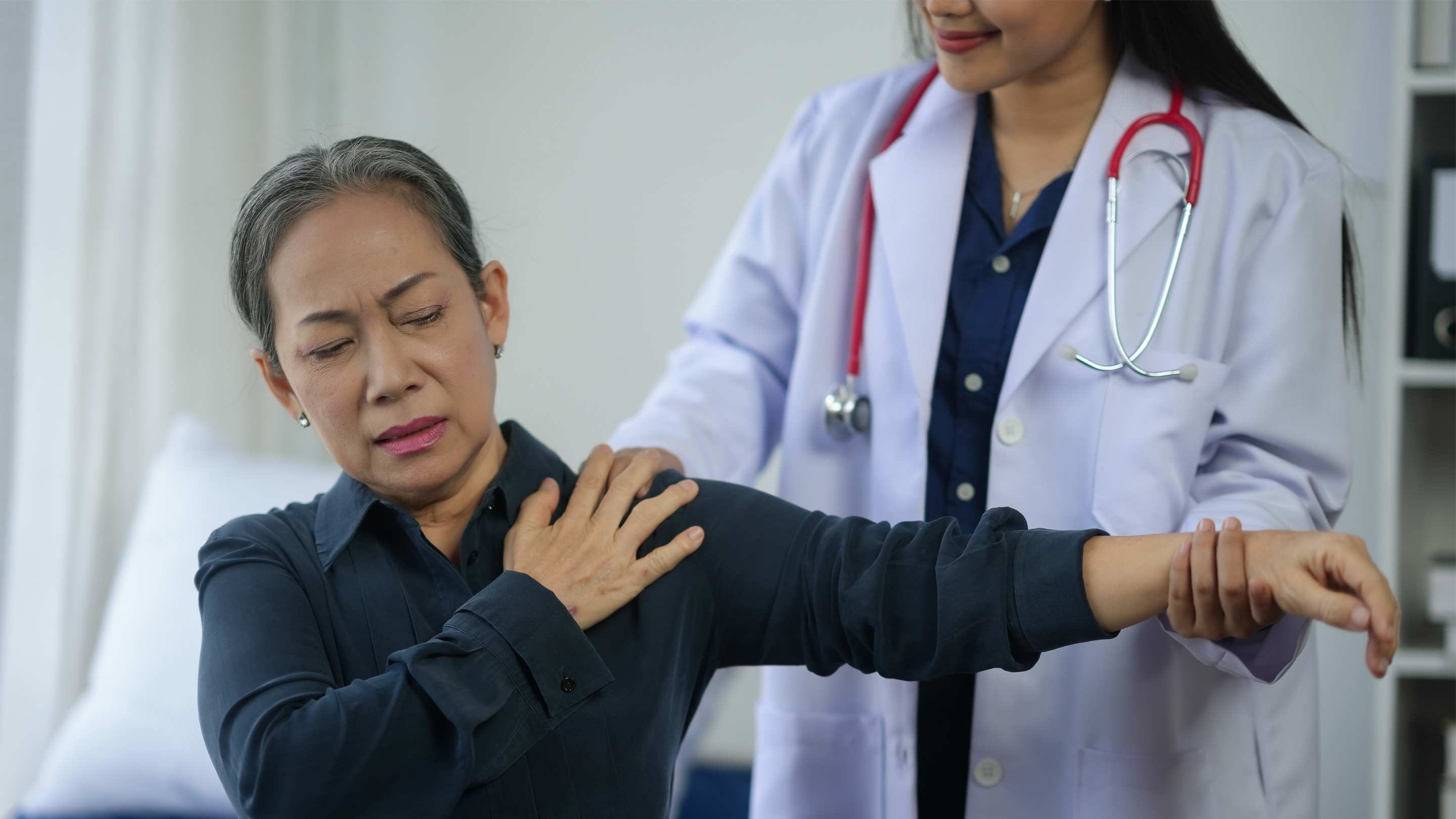 Physician treating older paitient with chronic pain.