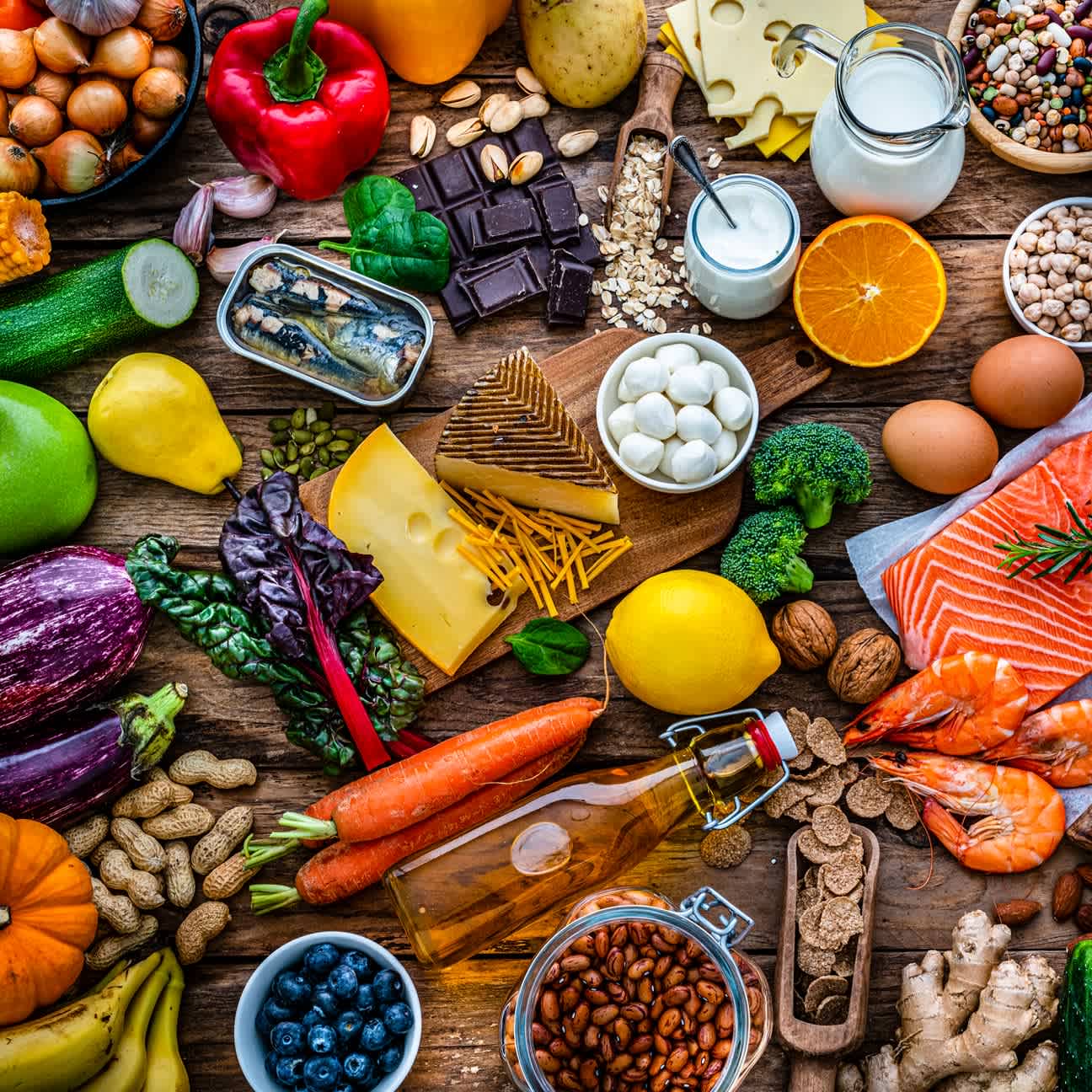 A display of healthy foods, fruits, vegetables, laid out on a table