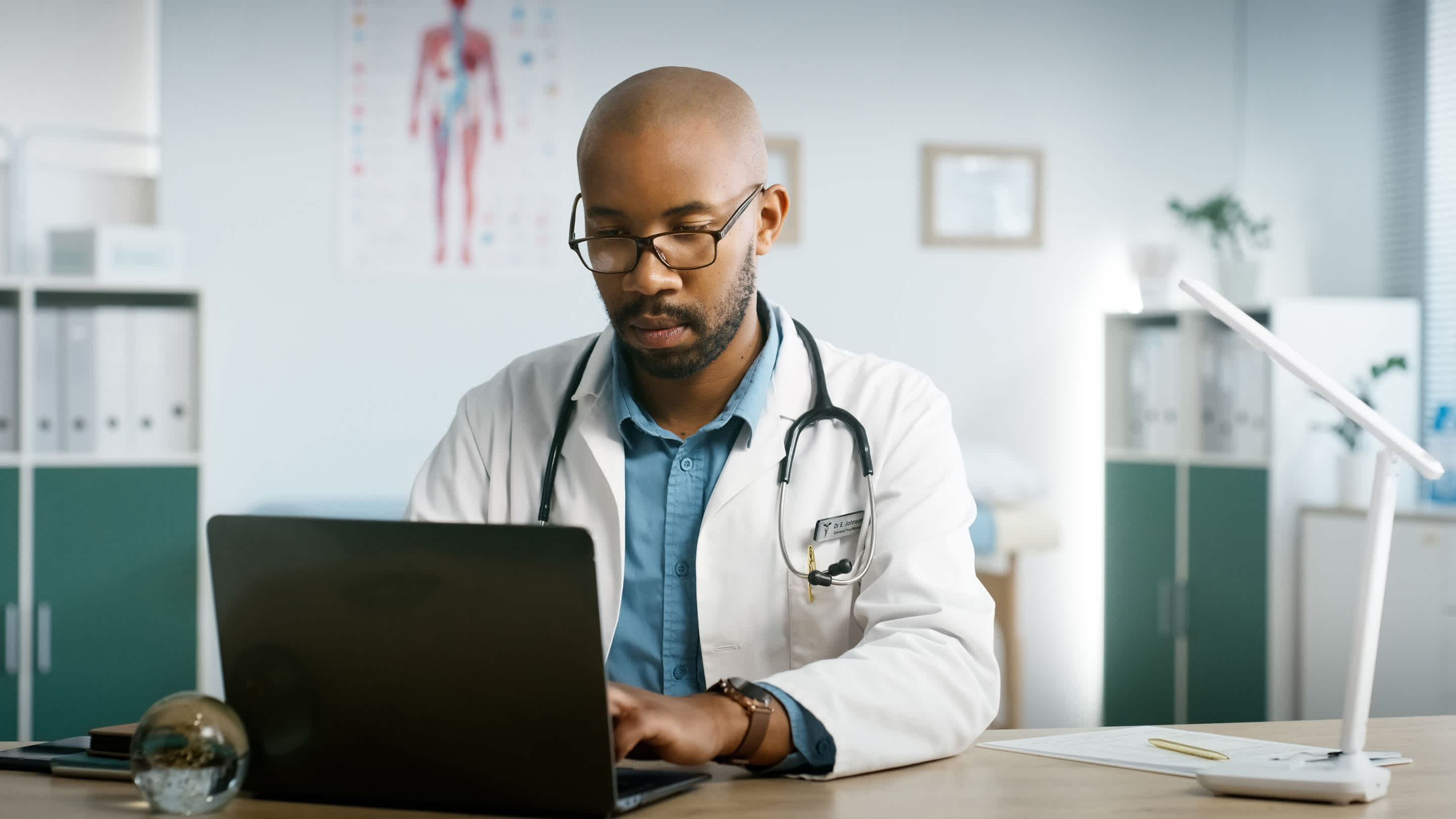 Image of Family Physician logging into the Member Portal on his laptop.