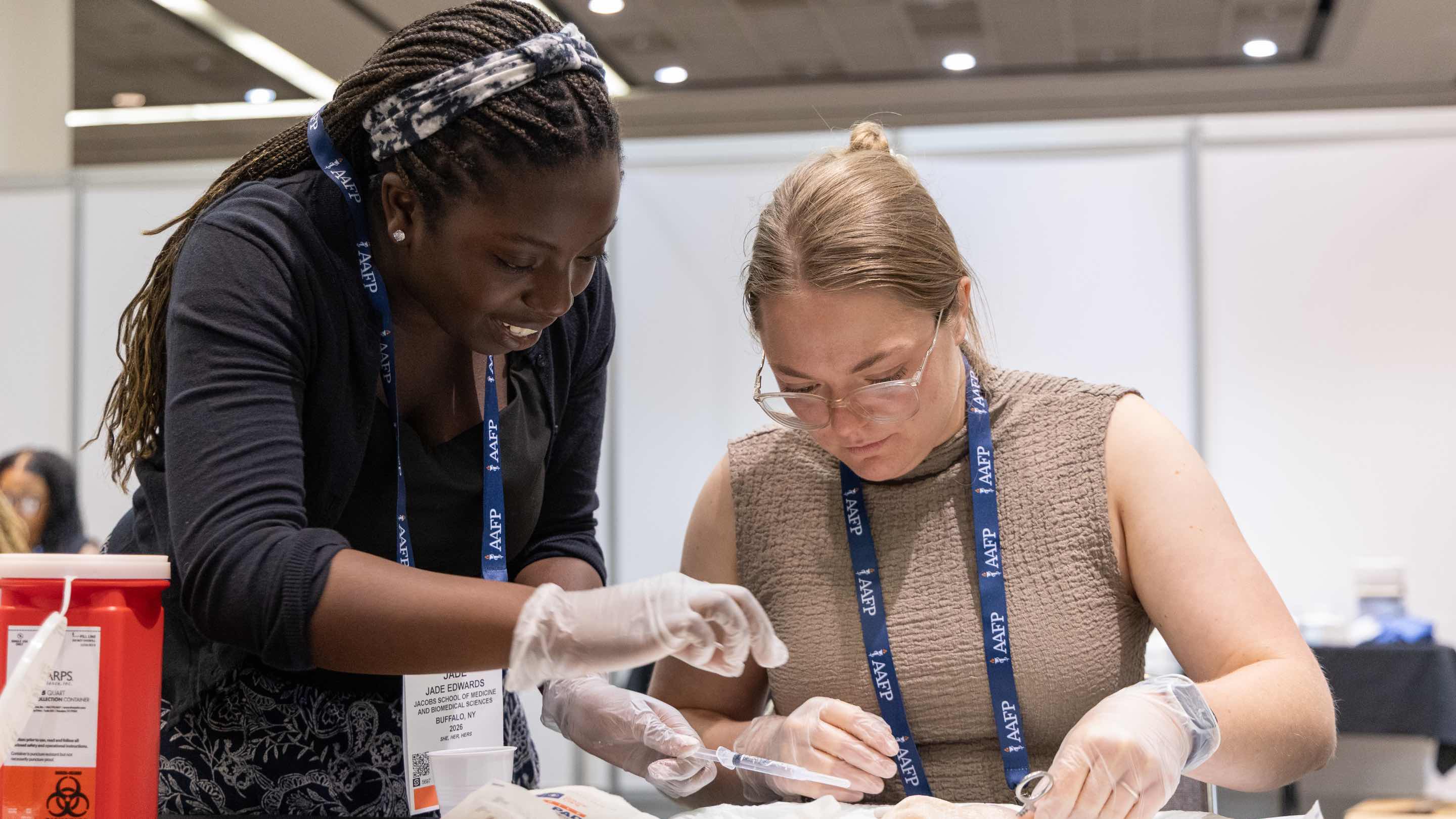 An instructor shares technique with medical student