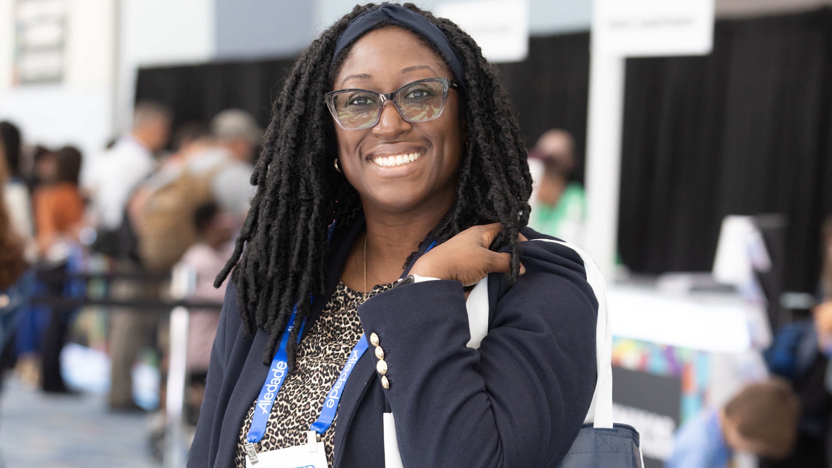 A female physician smiles at the FMX conference.