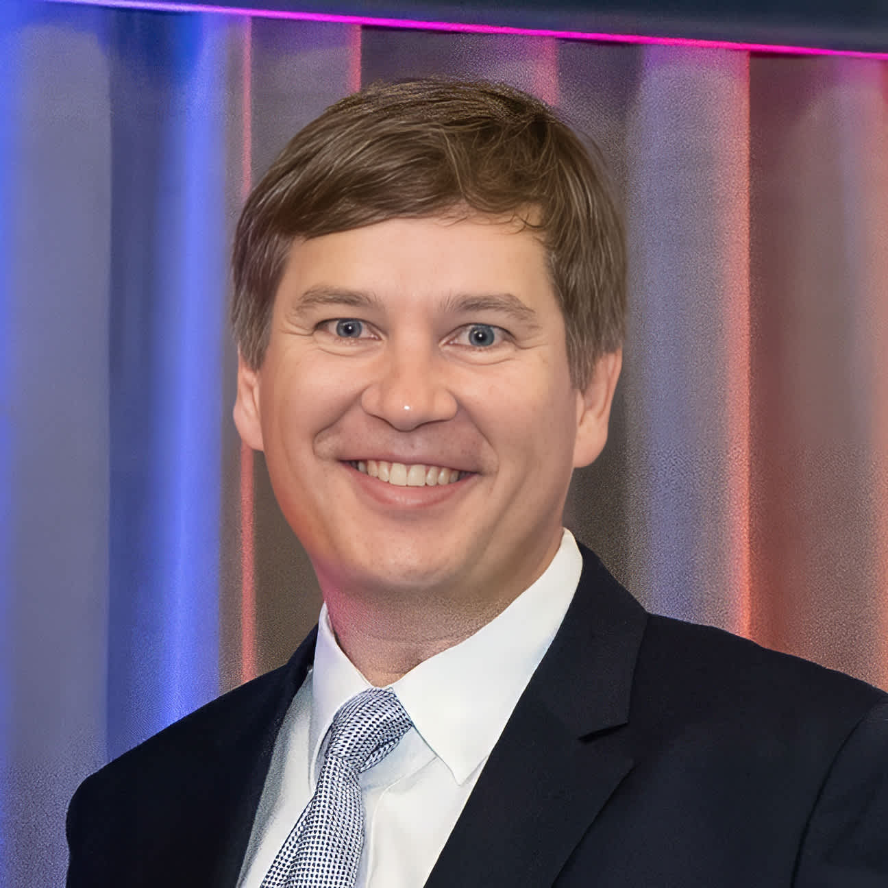 A male AAFP member smiles at the 2025 Degree of Fellow ceremony