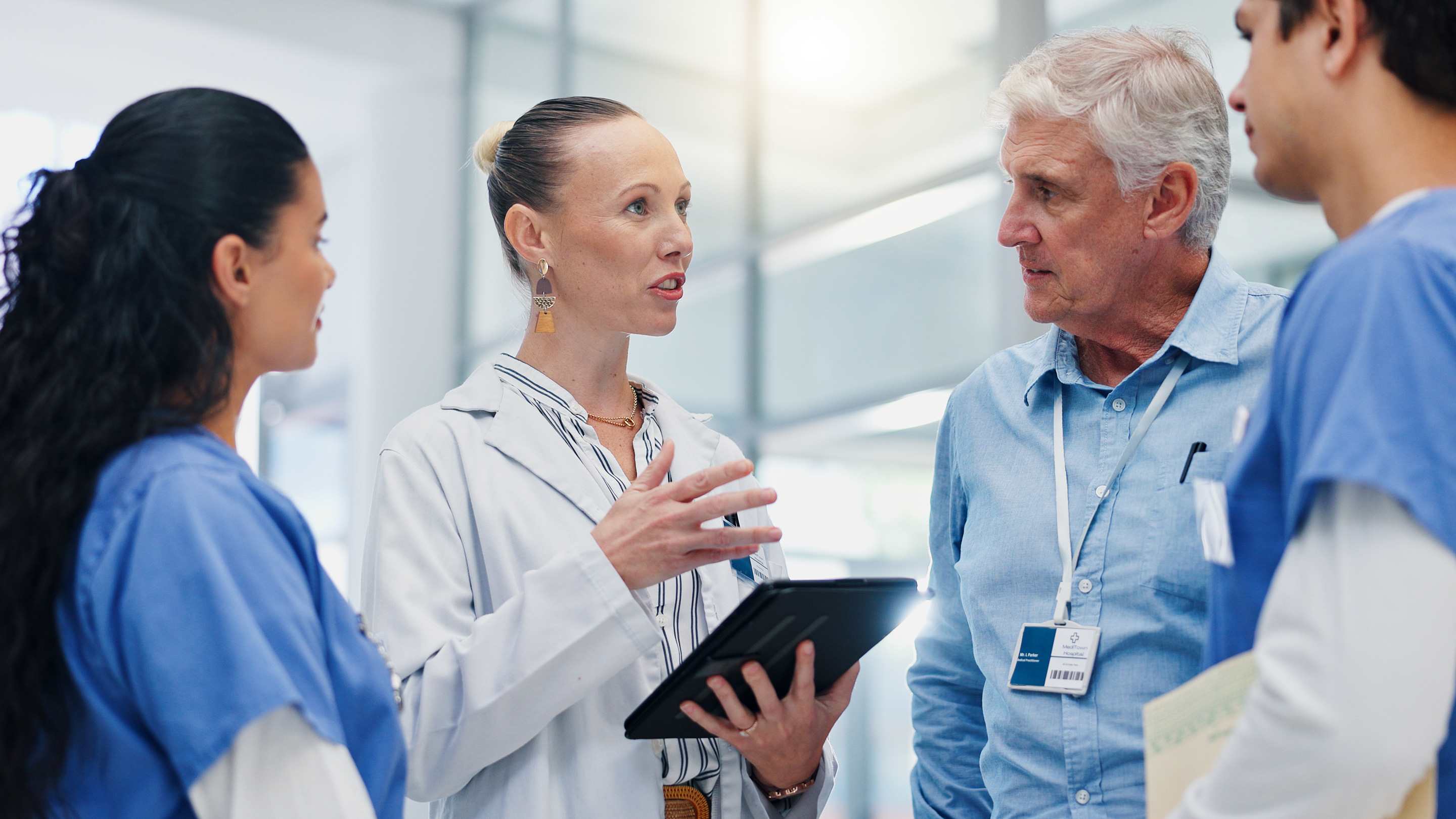 Image of physician and team planning in a hospital environment.