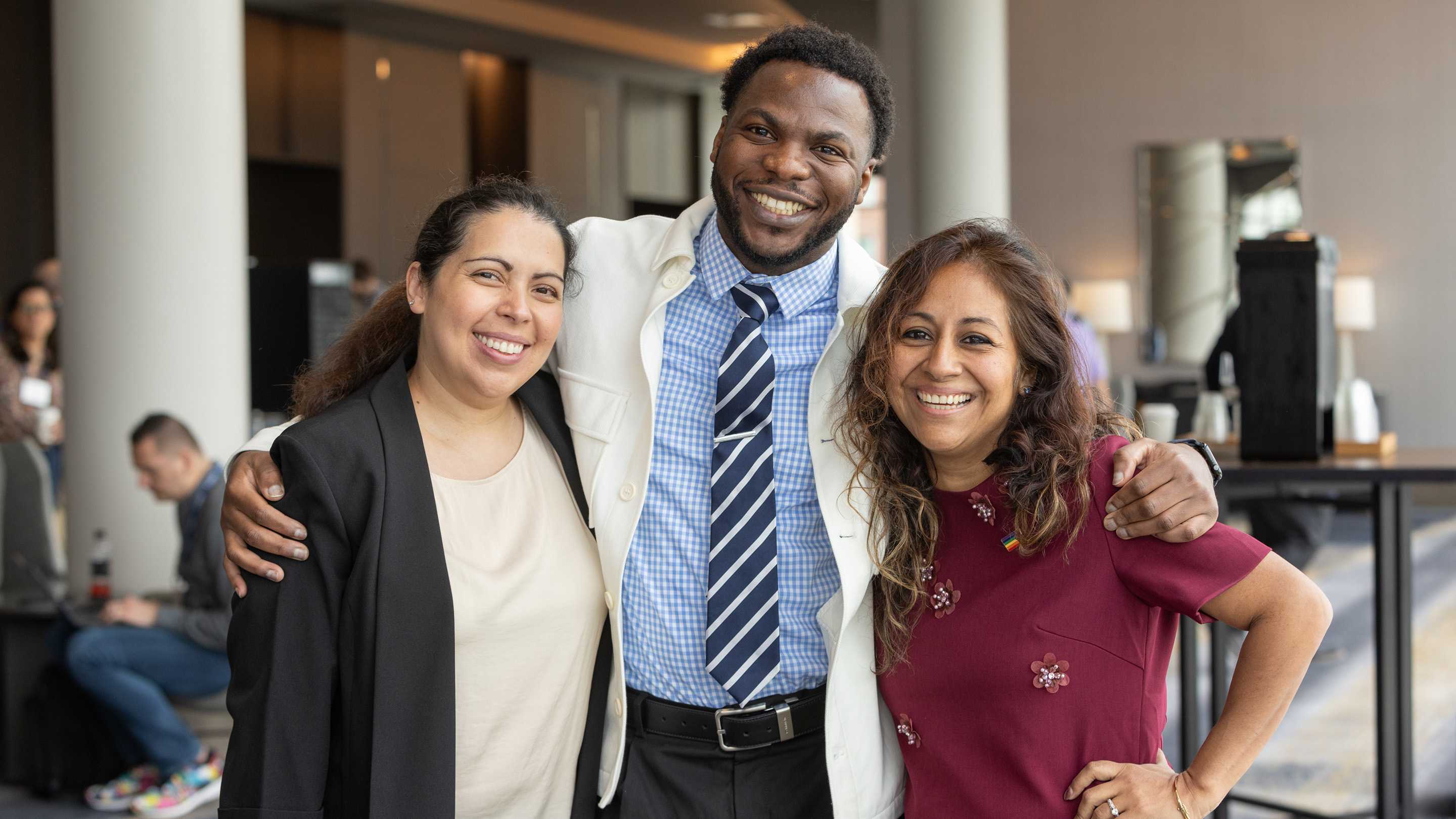 A group of three people smile for a photo at the leadership conference in 2025.