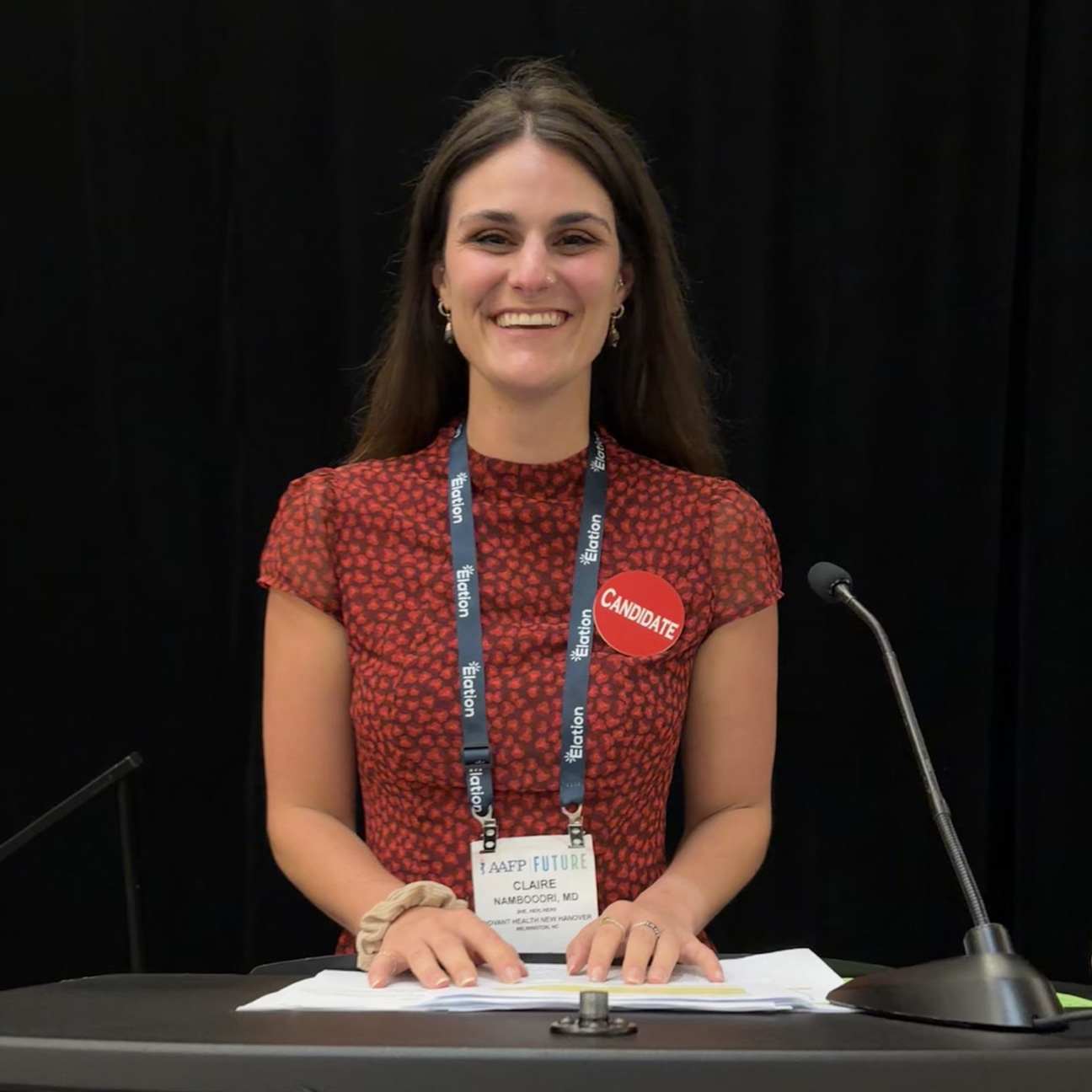 Claire Namboodri stands at a podium at the AAFP FUTURE conference.