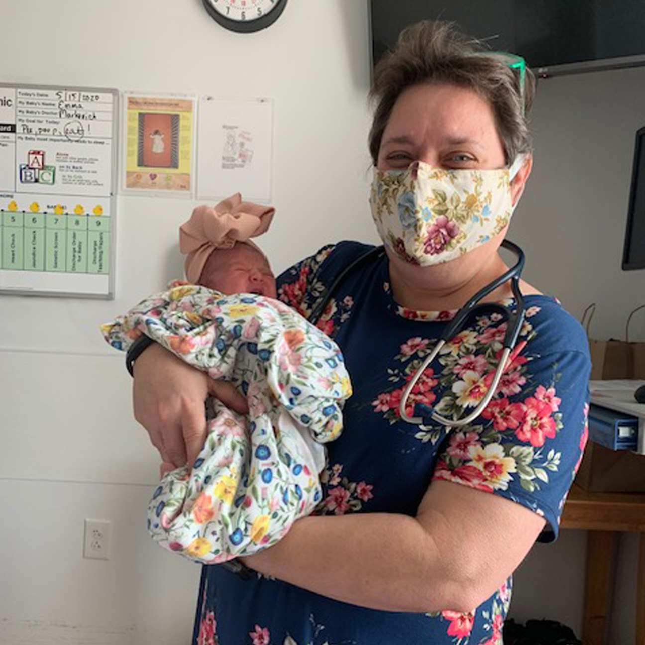 Renee Markovich, MD, holds a baby.